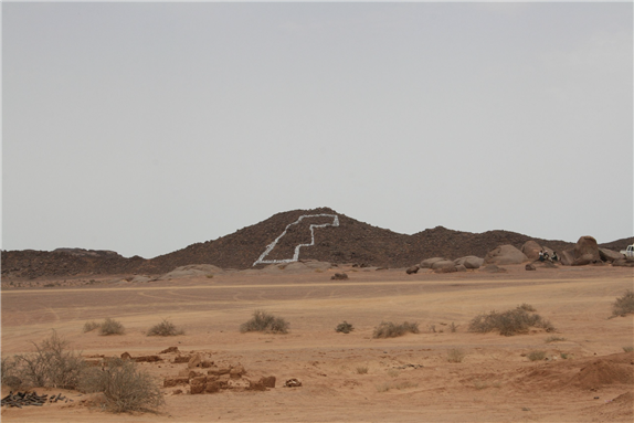 Small mountain near Tifariti in liberated Western Sahara. The map of Western Sahrara painted in white on the mountain. Taken in August 2009 via Wikimedia Commons
